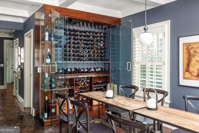 wine cellar with ornamental molding and beamed ceiling