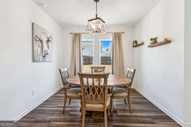 dining room featuring a notable chandelier and dark hardwood / wood-style flooring