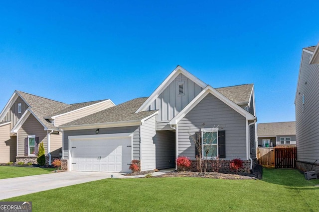 view of front of property with a front yard and a garage