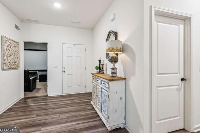 hallway with dark hardwood / wood-style flooring