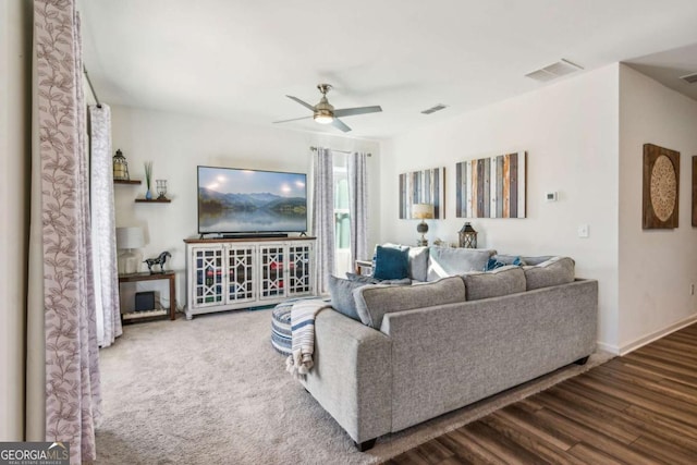 living room with ceiling fan and wood-type flooring