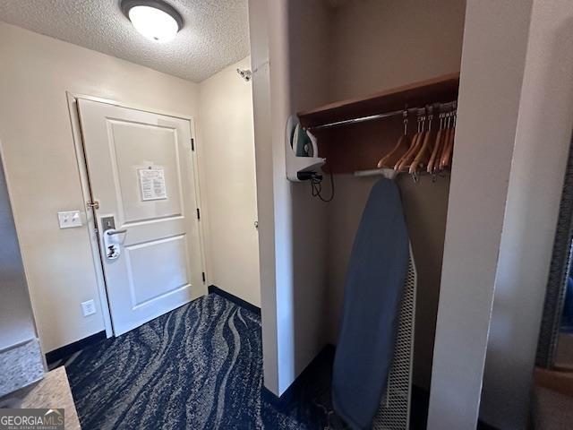 laundry area with dark tile patterned floors and washing machine and dryer