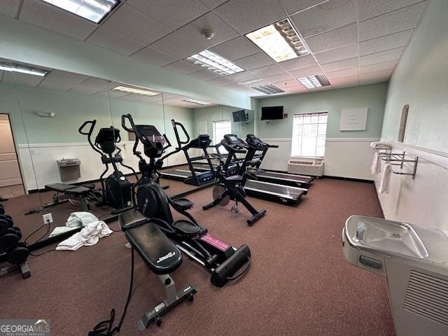 interior space featuring a paneled ceiling and light tile patterned floors