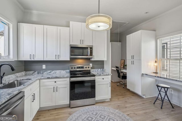 kitchen featuring stainless steel appliances, light hardwood / wood-style floors, white cabinetry, and sink