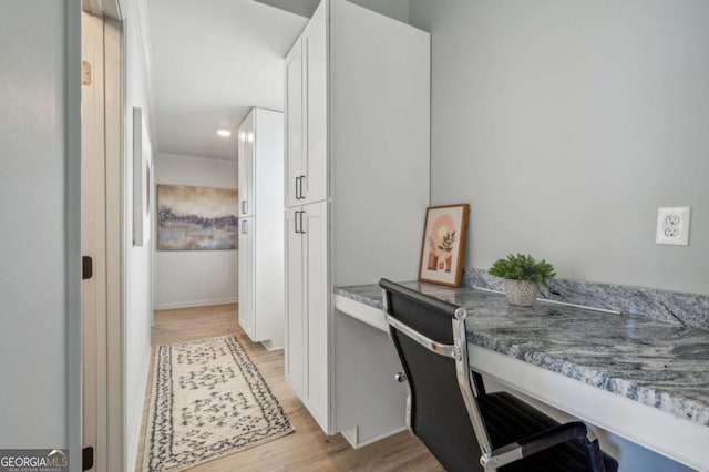 office area featuring built in desk and light hardwood / wood-style floors