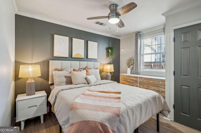 bedroom featuring ceiling fan, wood-type flooring, and crown molding