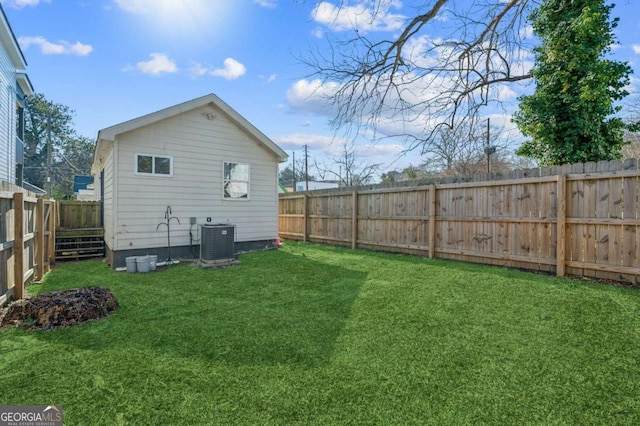 back of property featuring a lawn and central AC