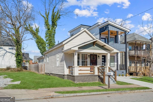 view of front of home featuring covered porch and a front lawn