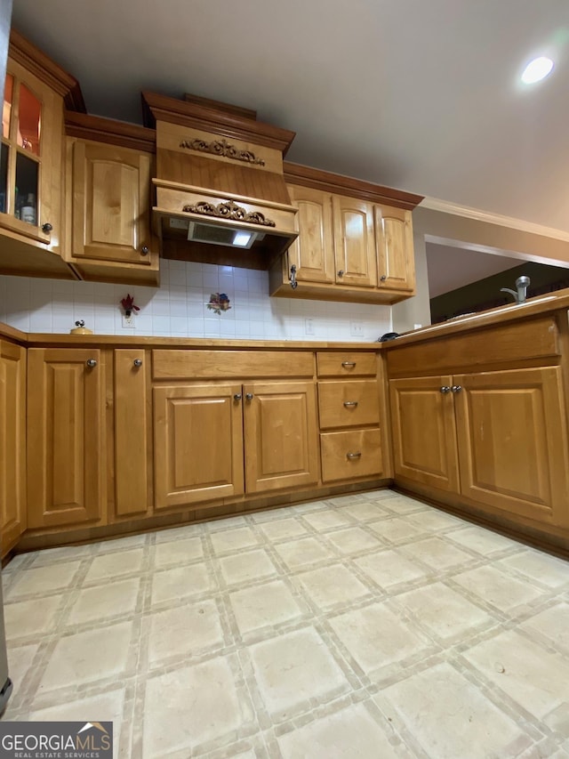 kitchen with backsplash and custom exhaust hood