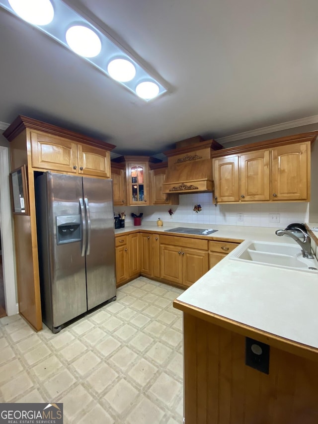 kitchen featuring sink, stainless steel fridge with ice dispenser, ornamental molding, custom range hood, and black electric stovetop