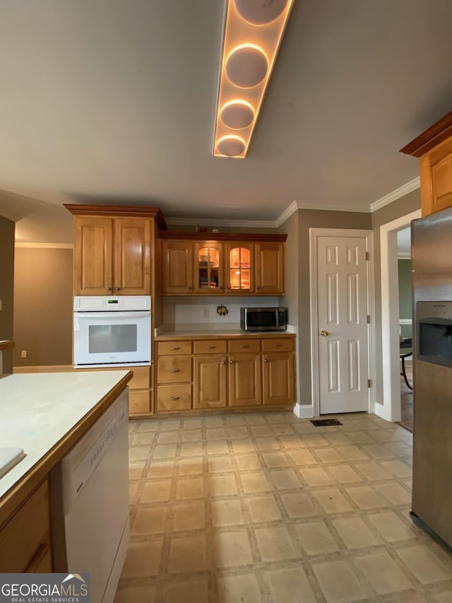 kitchen with crown molding and appliances with stainless steel finishes