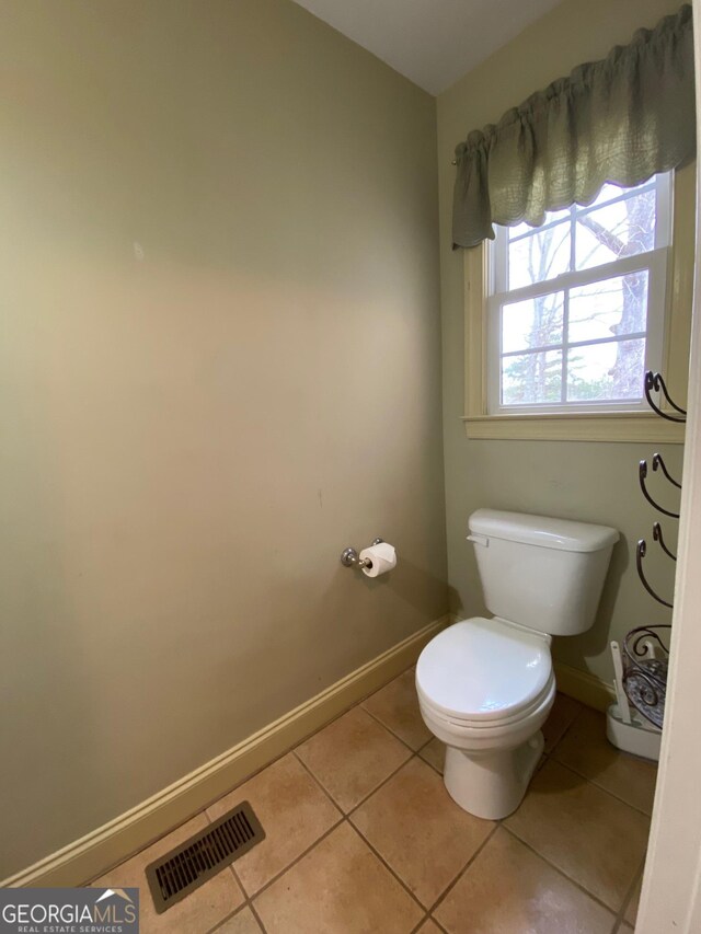 bathroom featuring tile patterned flooring and toilet