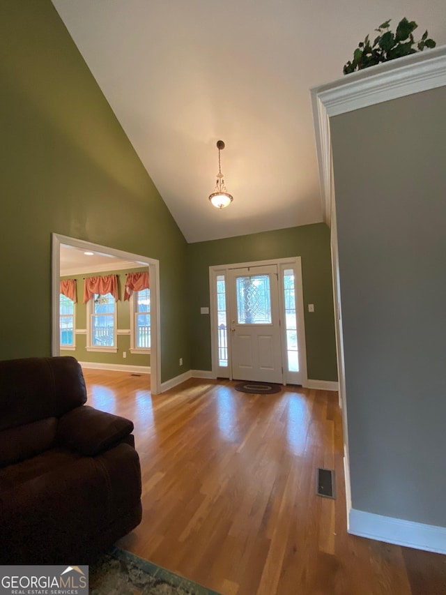 entrance foyer with plenty of natural light, high vaulted ceiling, and light wood-type flooring