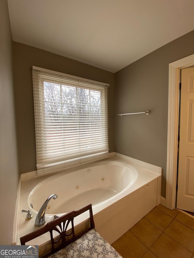 bathroom with tile patterned flooring and a bathtub