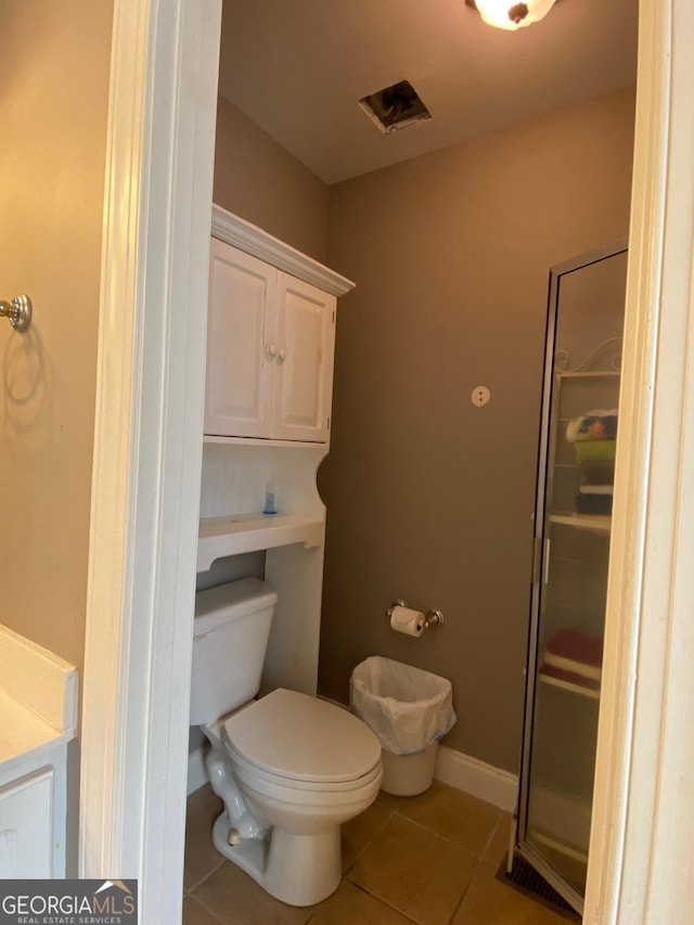 bathroom featuring tile patterned flooring and toilet