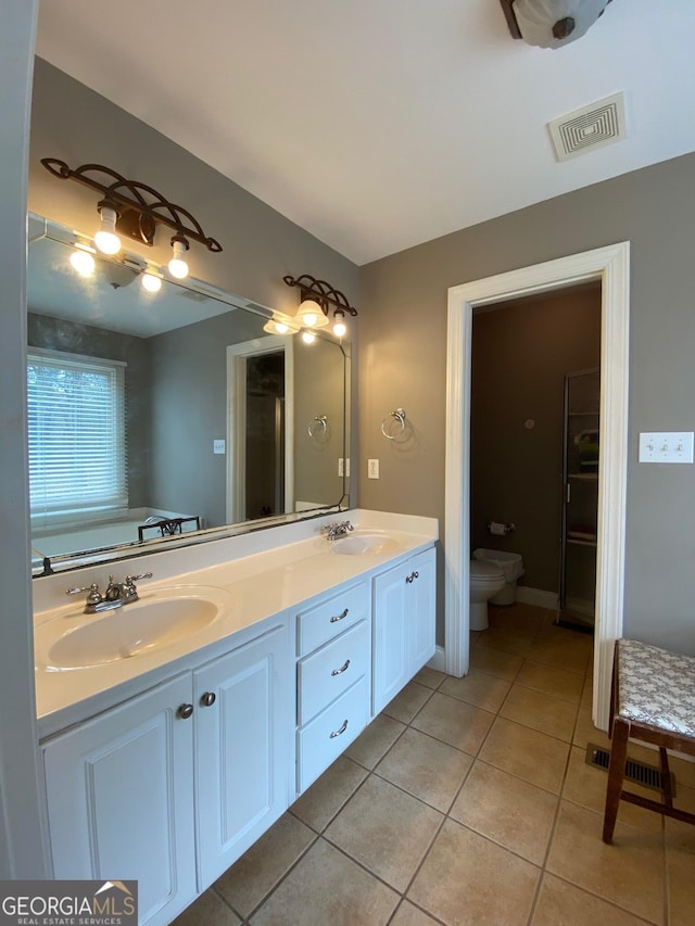 bathroom featuring vanity, tile patterned floors, and a bathtub