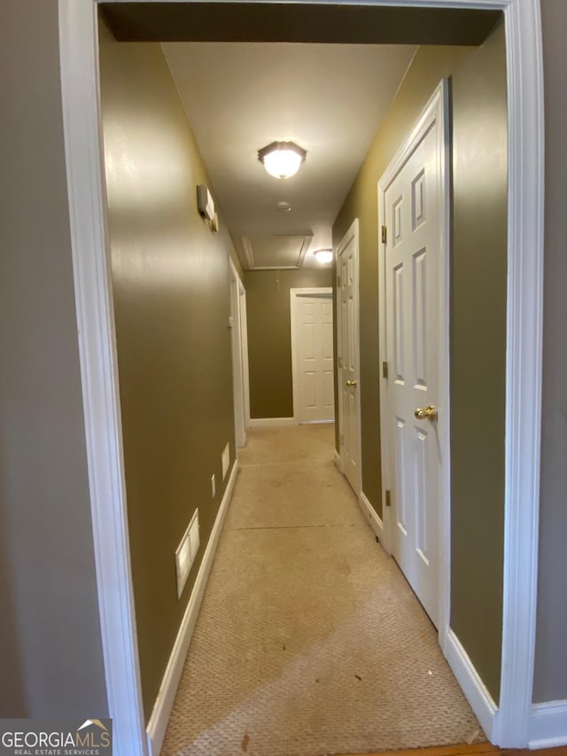 hall featuring light colored carpet