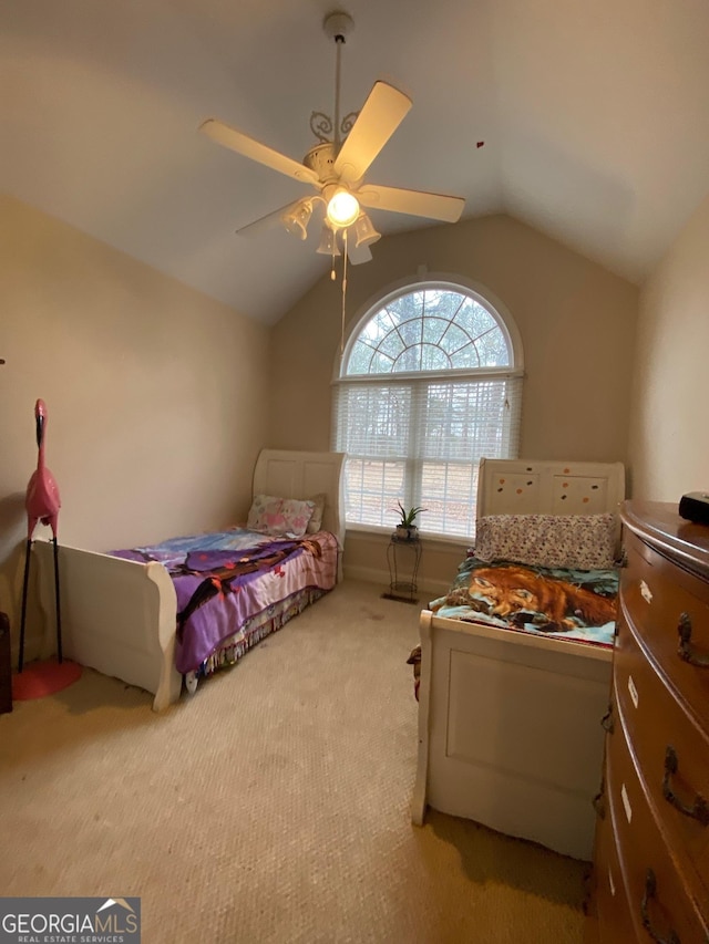 bedroom with ceiling fan, carpet flooring, and vaulted ceiling