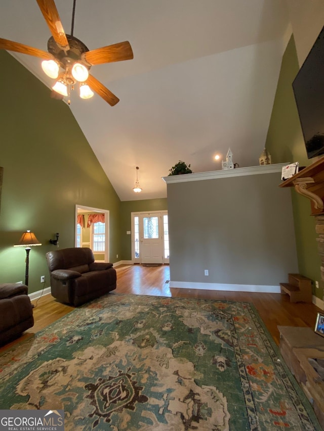 living room with wood-type flooring, ceiling fan, and high vaulted ceiling