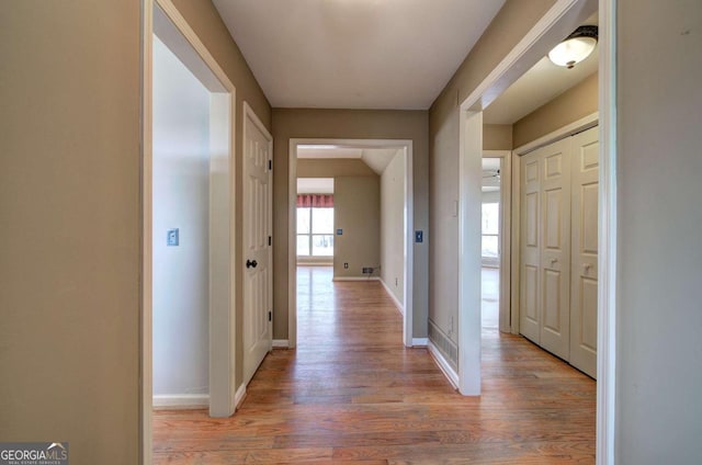 hall with hardwood / wood-style floors