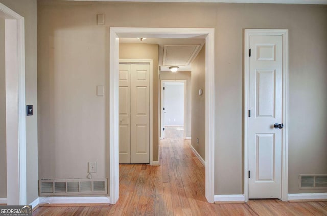 hallway with light hardwood / wood-style floors