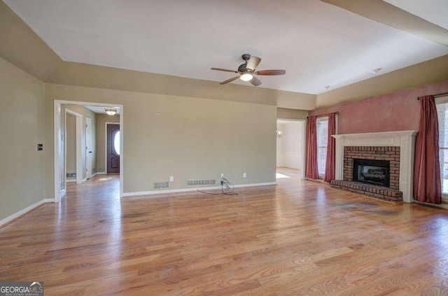 unfurnished living room featuring ceiling fan, light hardwood / wood-style floors, and a fireplace