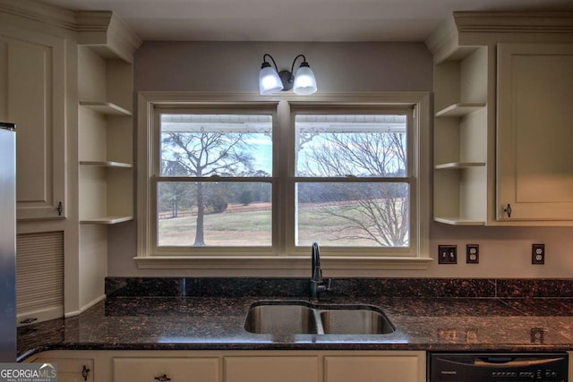 kitchen with black dishwasher, dark stone countertops, and sink