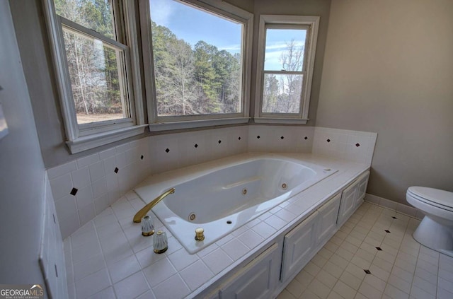 bathroom featuring toilet, tile patterned flooring, and a bathtub