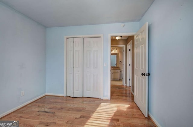 unfurnished bedroom featuring a closet and light hardwood / wood-style flooring