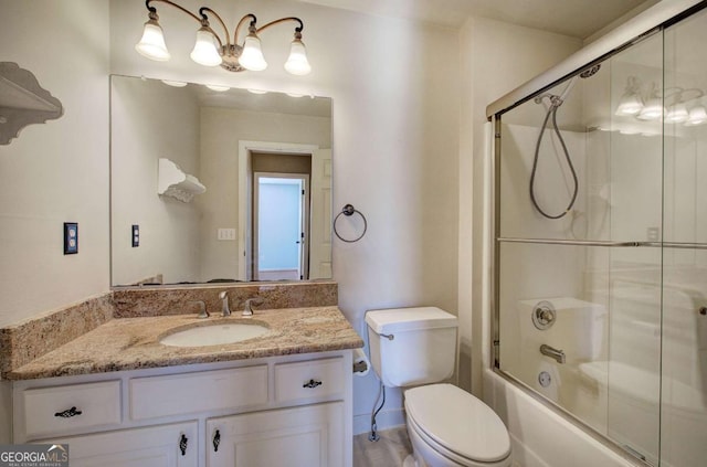 full bathroom featuring toilet, vanity, and combined bath / shower with glass door