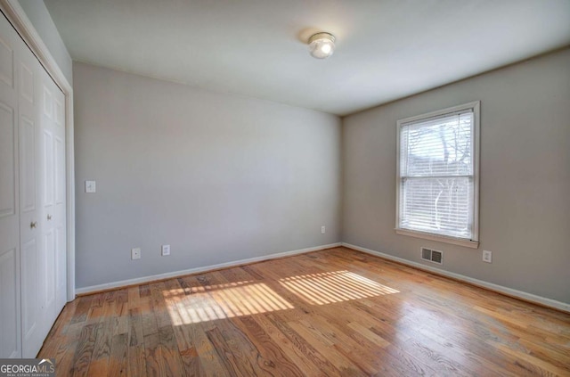 spare room with light hardwood / wood-style flooring