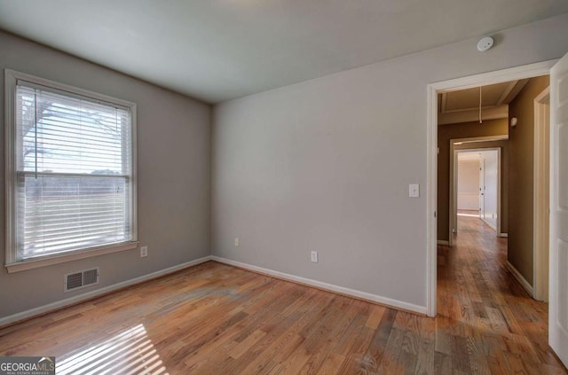 unfurnished room featuring hardwood / wood-style flooring