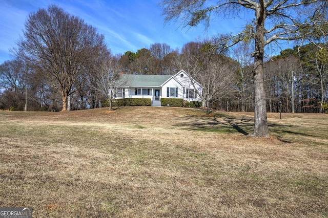 ranch-style home with a porch and a front yard