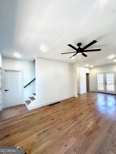 unfurnished room with french doors, ceiling fan, and hardwood / wood-style flooring