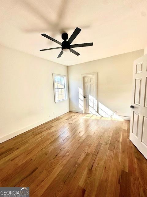 empty room featuring ceiling fan and wood-type flooring