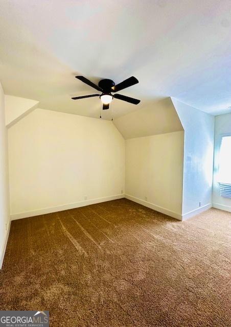 additional living space with ceiling fan, carpet, and lofted ceiling