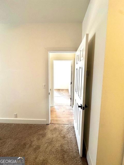 hallway with dark carpet