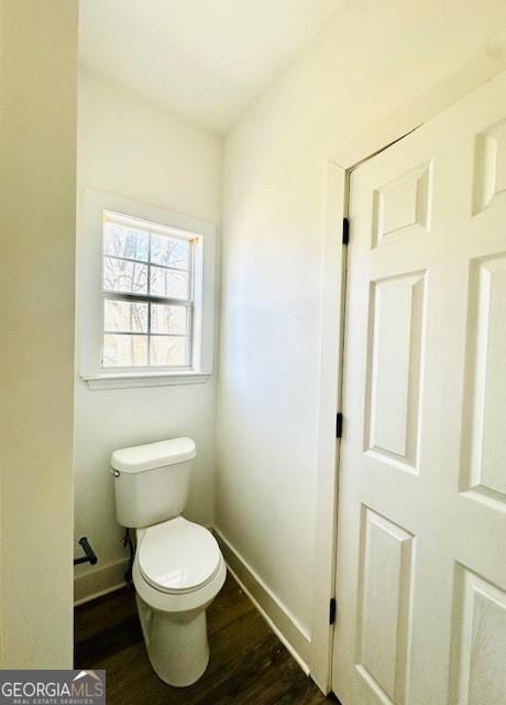 bathroom with toilet and hardwood / wood-style flooring