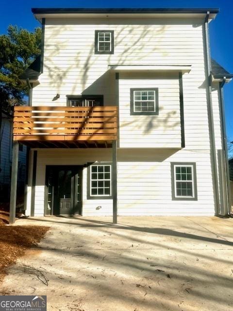 back of house with a balcony