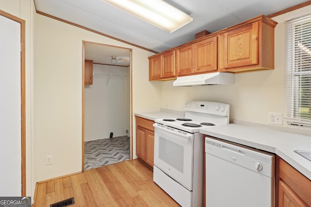 kitchen featuring lofted ceiling, white appliances, and light hardwood / wood-style flooring