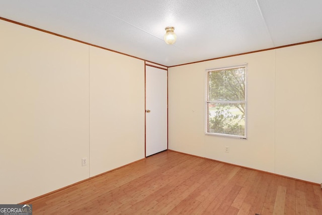 unfurnished room with light wood-type flooring