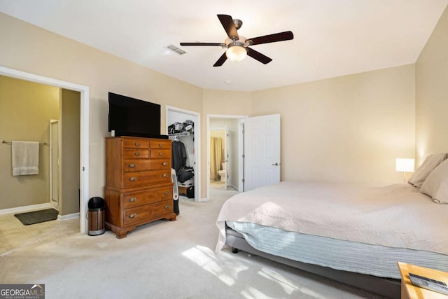 carpeted bedroom featuring ceiling fan, a closet, and a spacious closet