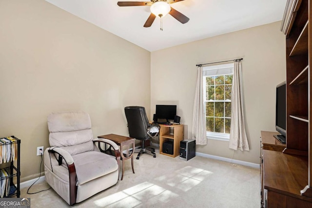 carpeted office space with ceiling fan