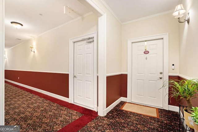 foyer featuring ornamental molding and carpet floors