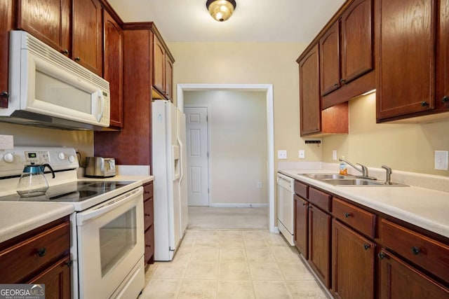 kitchen featuring sink and white appliances