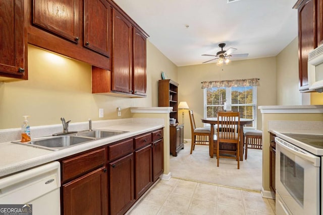 kitchen featuring ceiling fan, sink, white appliances, and light colored carpet