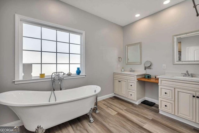 bathroom featuring a bathtub, hardwood / wood-style floors, and vanity