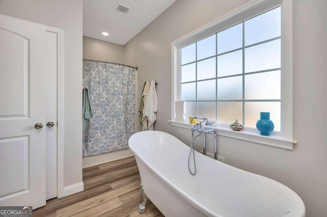 bathroom featuring hardwood / wood-style floors and a bathtub