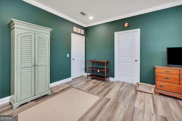 sitting room with a textured ceiling, ornamental molding, and light hardwood / wood-style floors