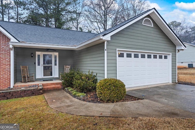 single story home featuring a garage and a porch